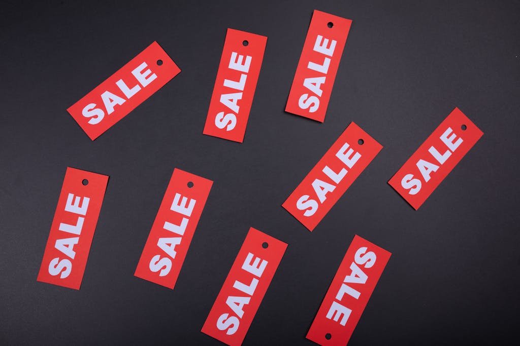 Red sale tags on a black background. Ideal for marketing and promotional use.